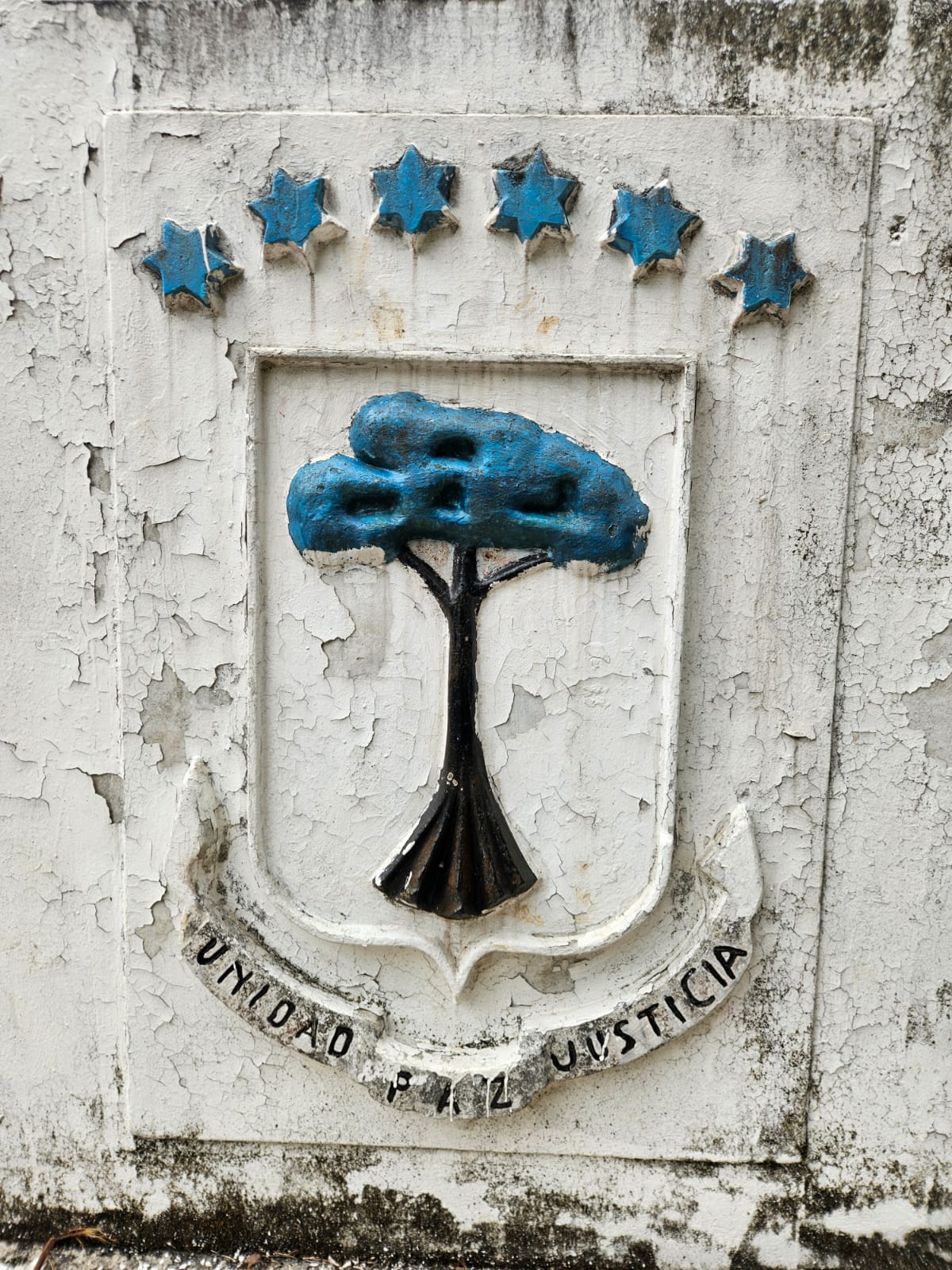 Old emblem on a wall in Equatorial Guinea
