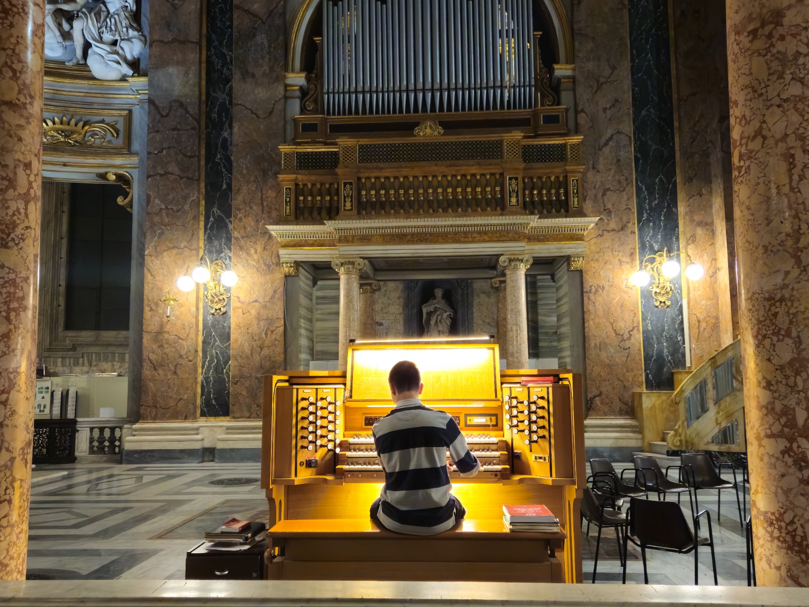 Organ player inside the Basilica of Sant'Ambrogio e Carlo al Corso in Rome