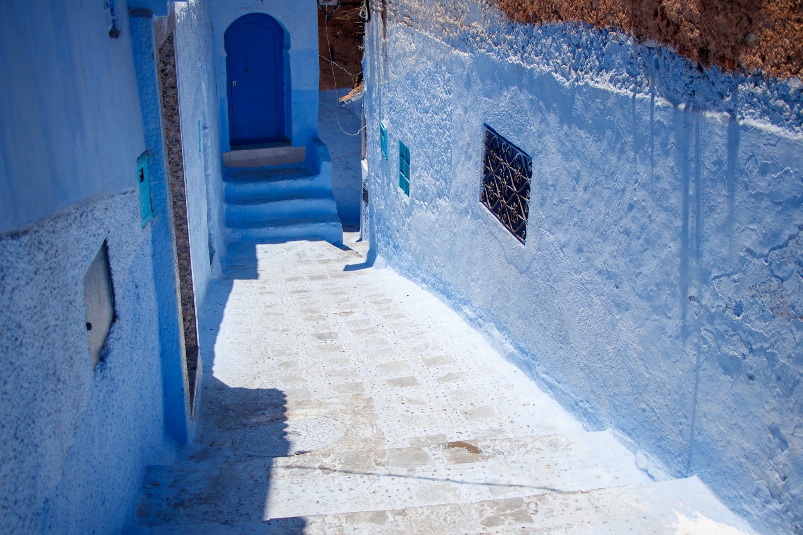 Blue doorway and courtyard in Chefchaouen, Morocco