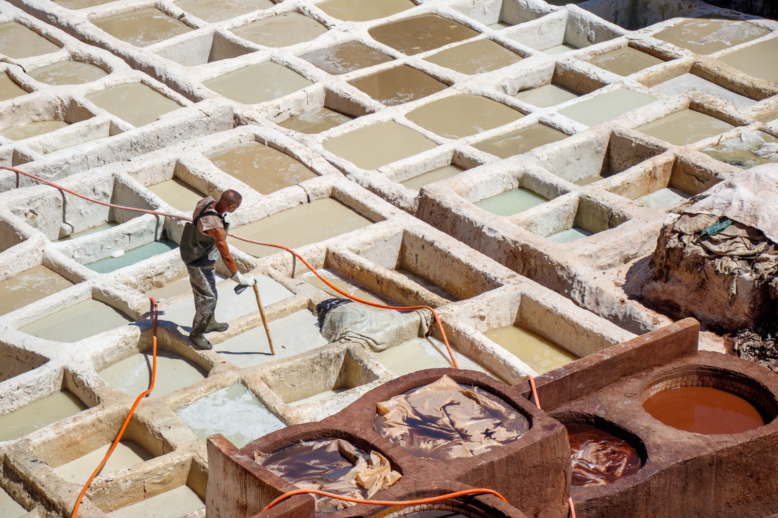 Workers processing leather at Chouara Tannery in Fes, Morocco